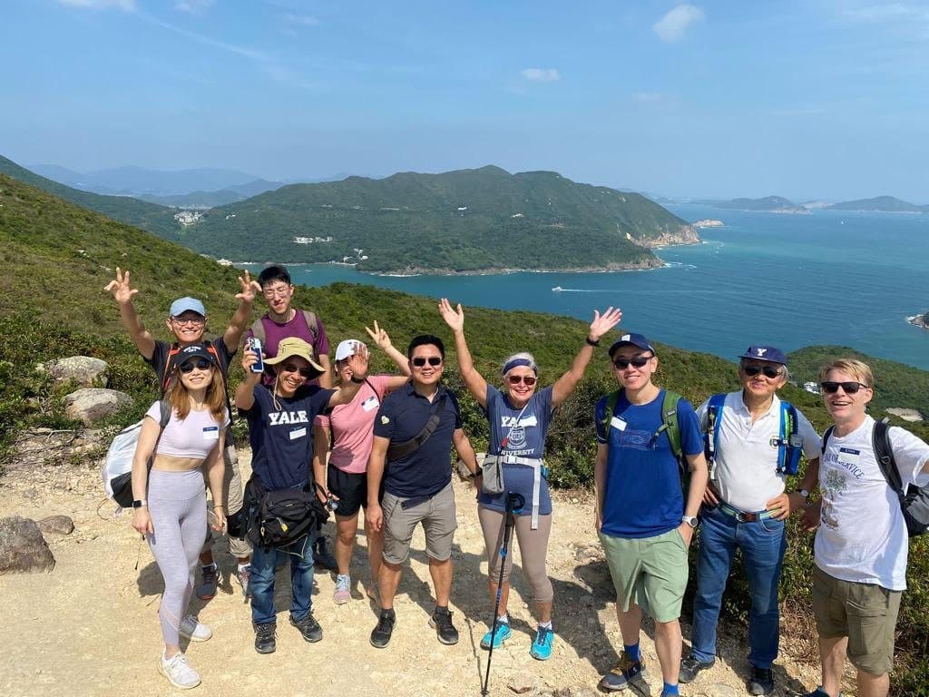 Hikers celebrating on High Junk Peak above the sea