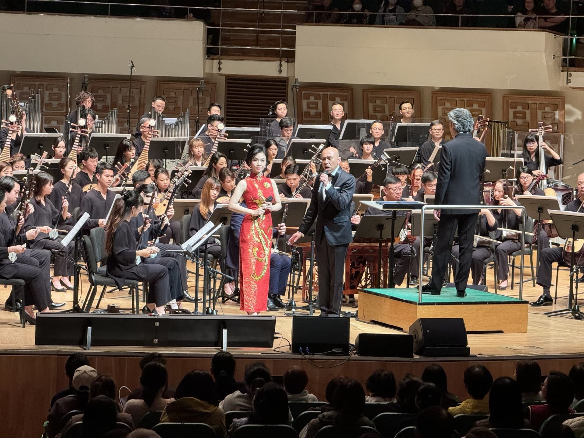 A soprano performing with a full Chinese orchestra